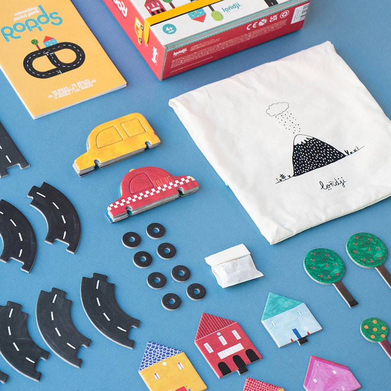 pocket-game-roads Children's playset with road pieces, houses, and a taxi on a blue background