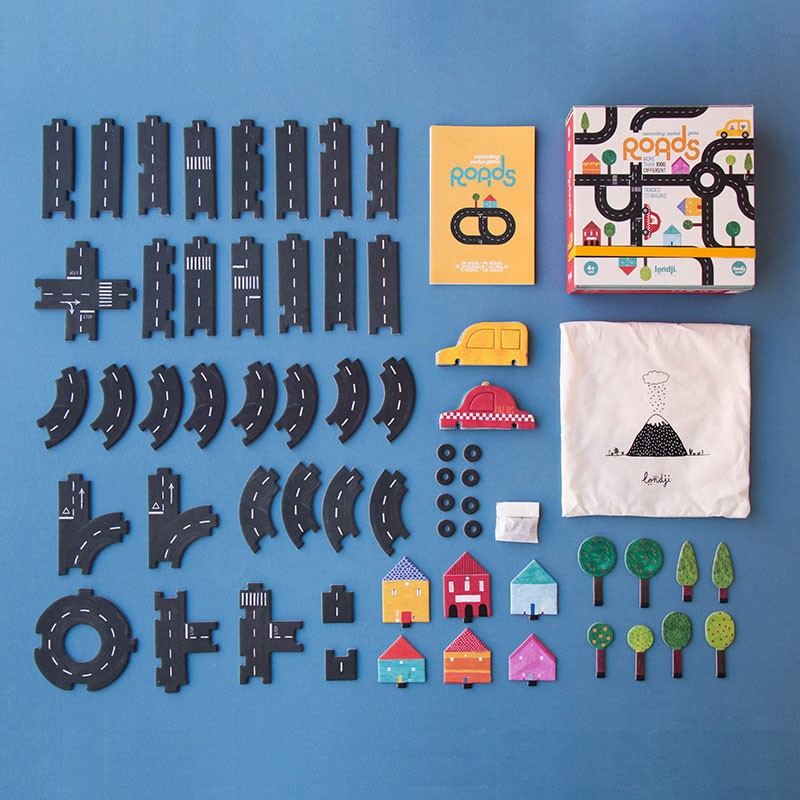 pocket-game-roads Board game components including roads, houses, trees, and a box on a blue background