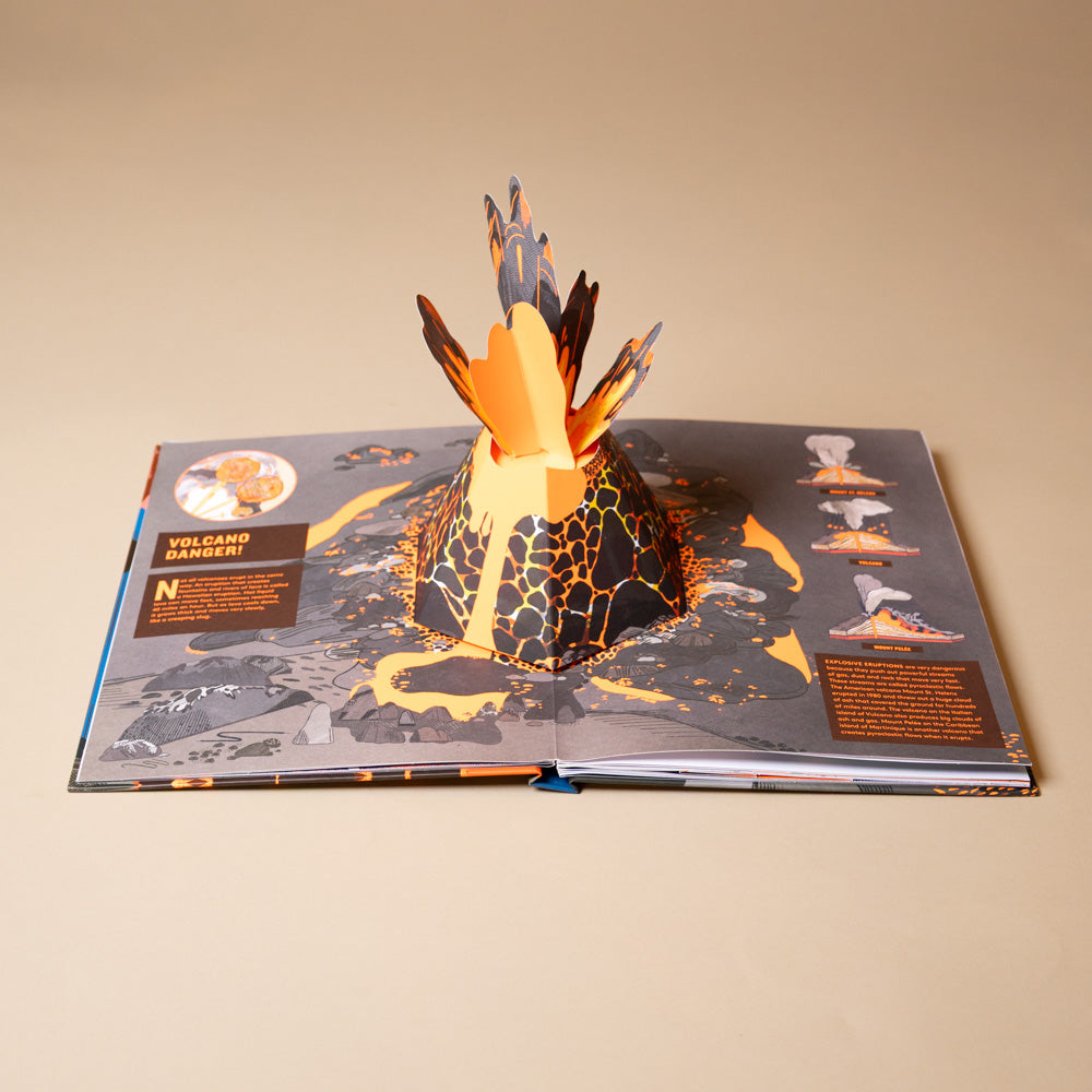 pop-up-volcano-book Open book with a 3D volcano model on a beige background