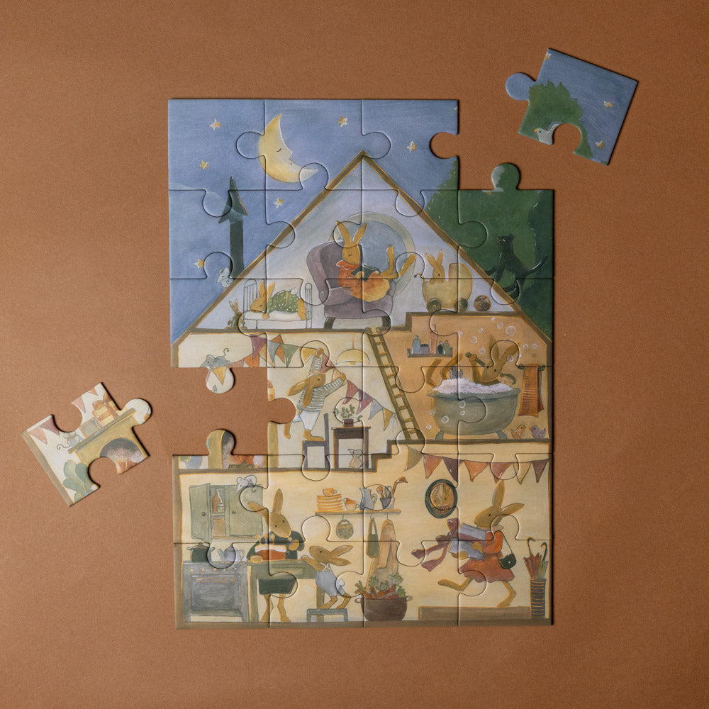 rabbit-family-house-puzzle Jigsaw puzzle with a completed section on a brown background