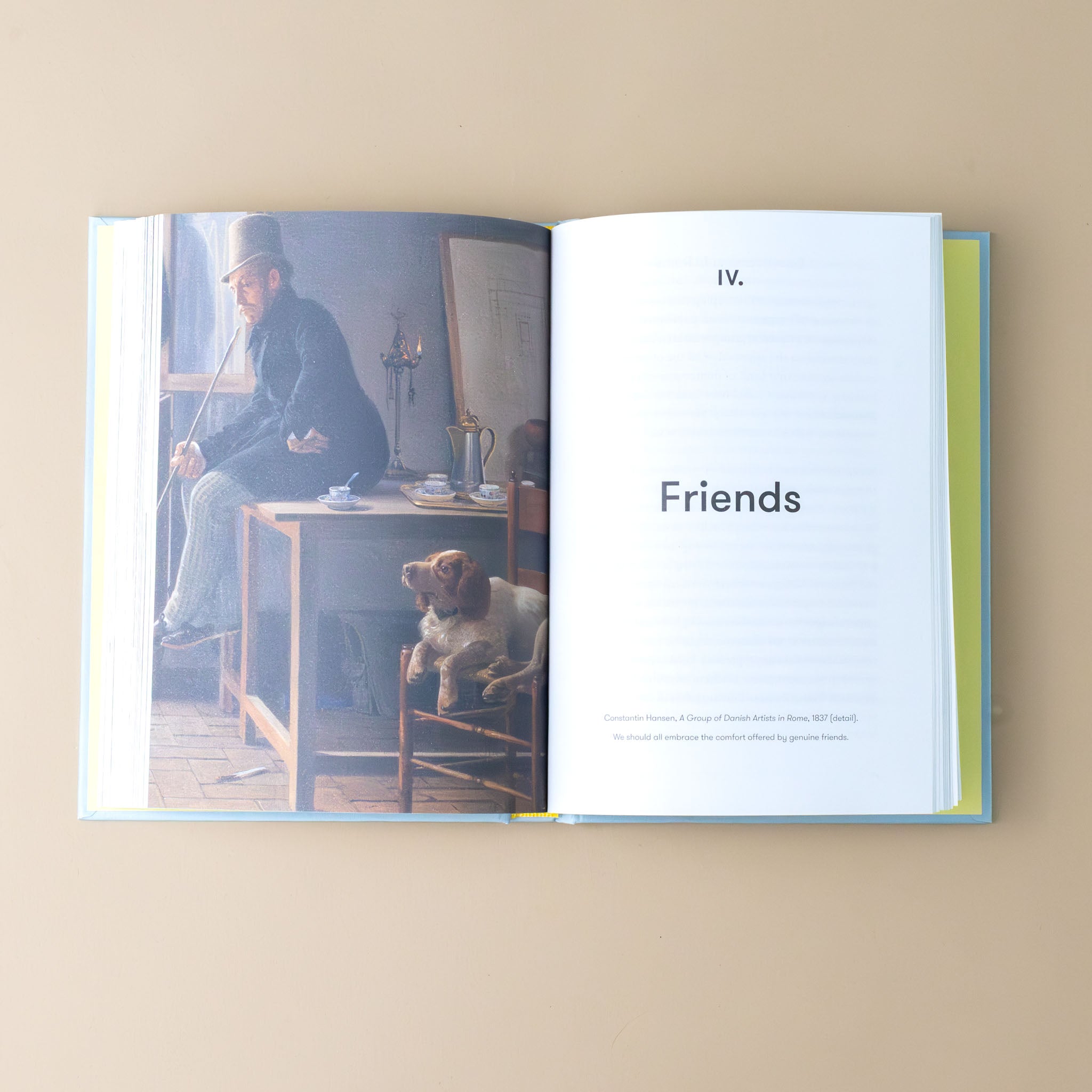 reasons-to-be-hopeful-book-interior-page-with-a-dog-next-to-a-man-sitting-on-a-dest-text-friends