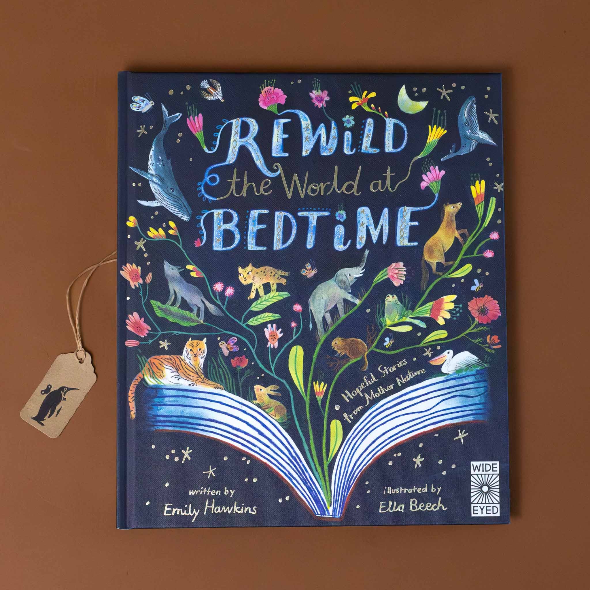 rewild-the-world-at-bedtime-navy-cover-with-colorful-flowers-and-animals-adorning