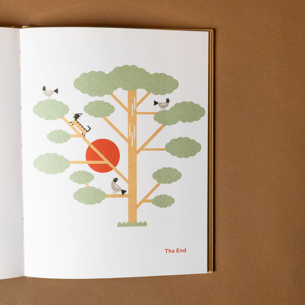 shigeru-ban-build-a-better-world Illustration of a tree with animals and a red circle on a white page, framed against a brown background.