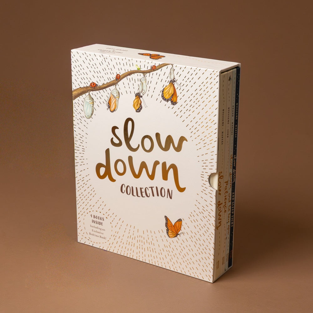 box of books titled 'slow down collection' with butterfly illustration on a brown background