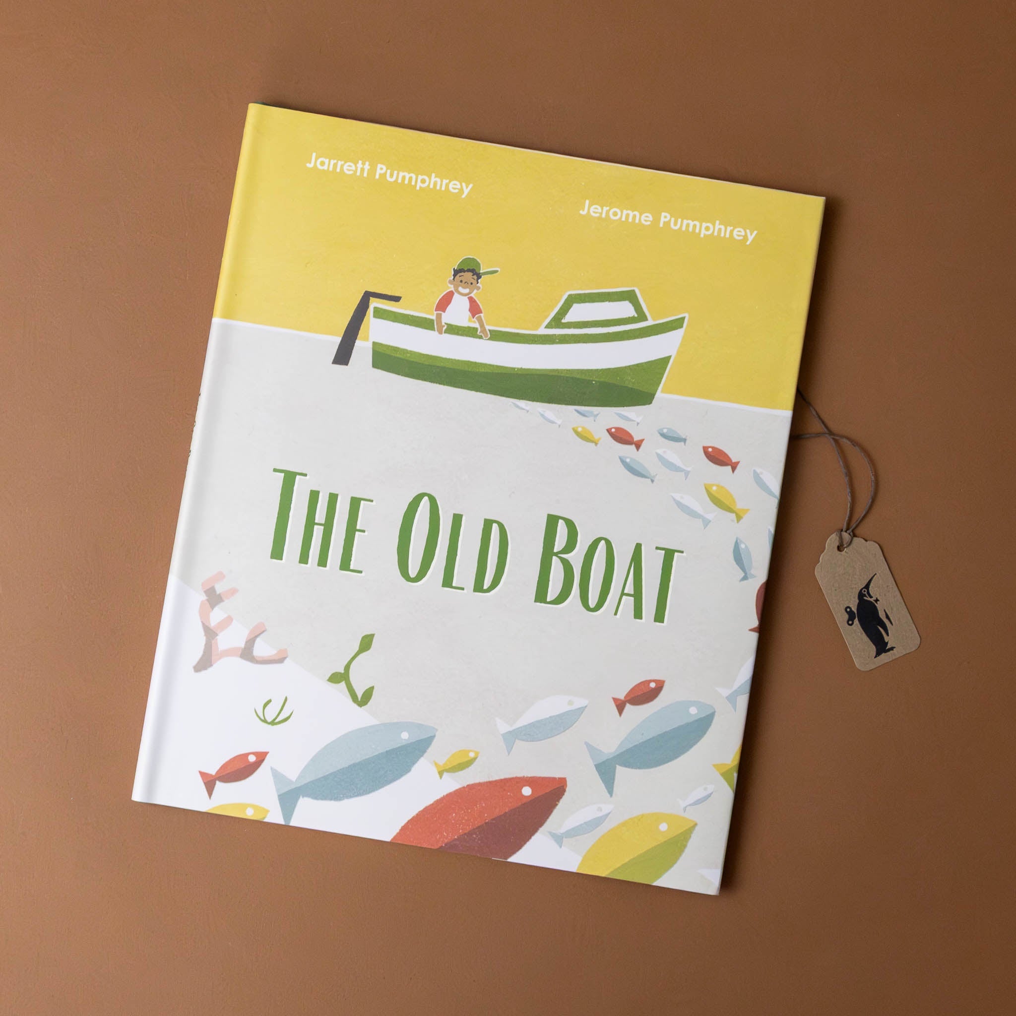 the-old-boat-book-cover-with-boat-over-fish-with-a-sunny-sky-behind