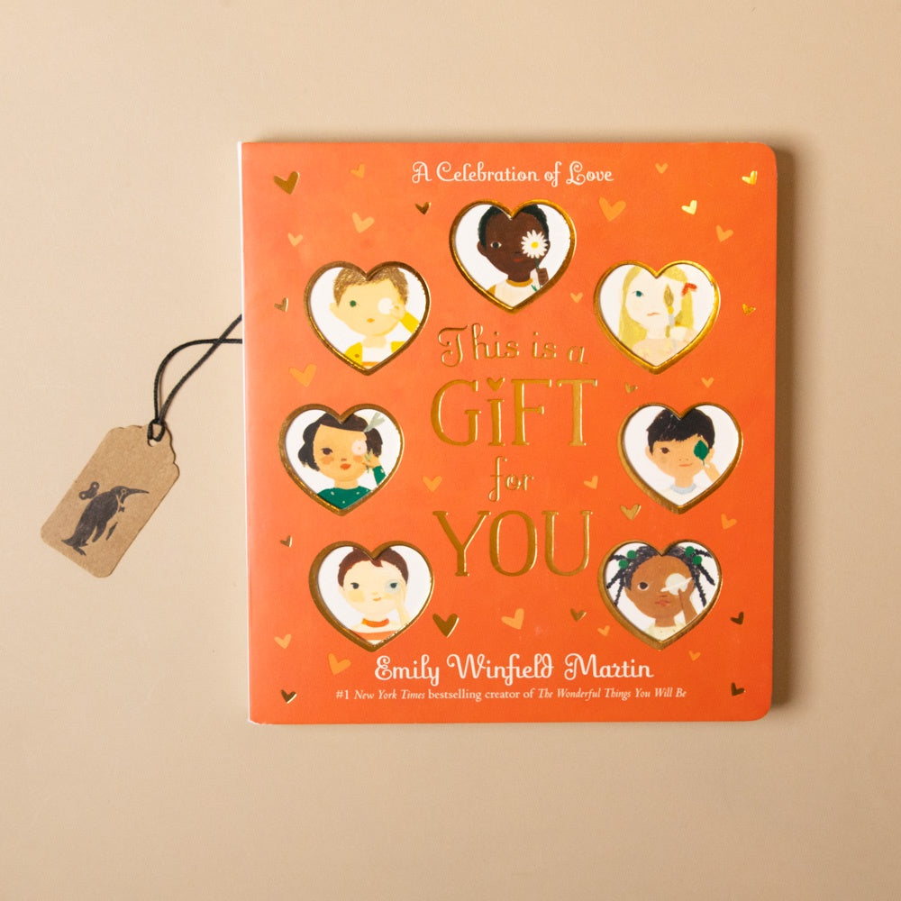 Book titled 'This is a Gift for You' with heart-shaped illustrations on an orange cover, featuring Emily Winfield Martin's name.