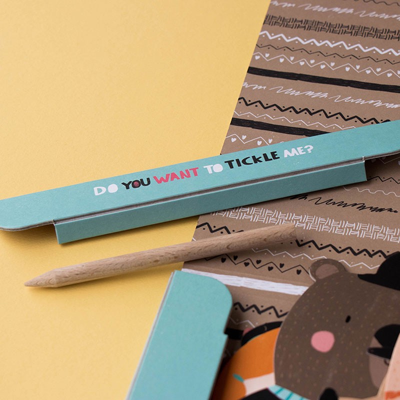 tickle-me-arts-and-crafts-kit Children's book with a teddy bear illustration and a wood pen tool on a yellow background