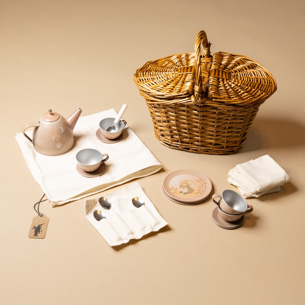 Tea set with wicker basket on a beige background
