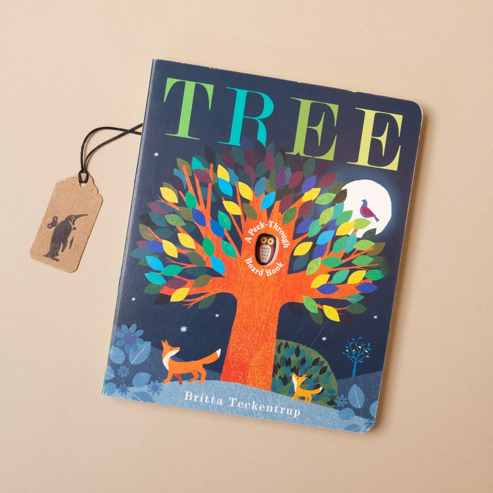 Children's book titled 'TREE' with a colorful tree illustration on the cover, featuring a fox and birds, on a beige background.