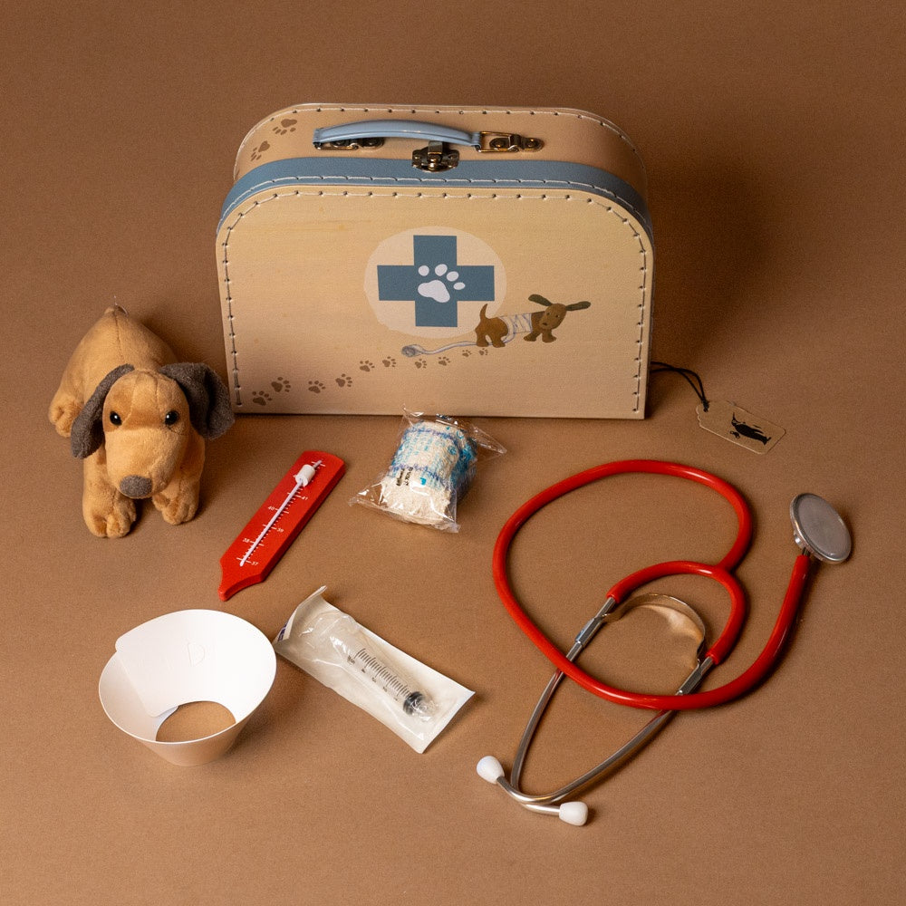 veterinary-case Children's toy medical kit with stethoscope, syringe, and plush dog on a brown background