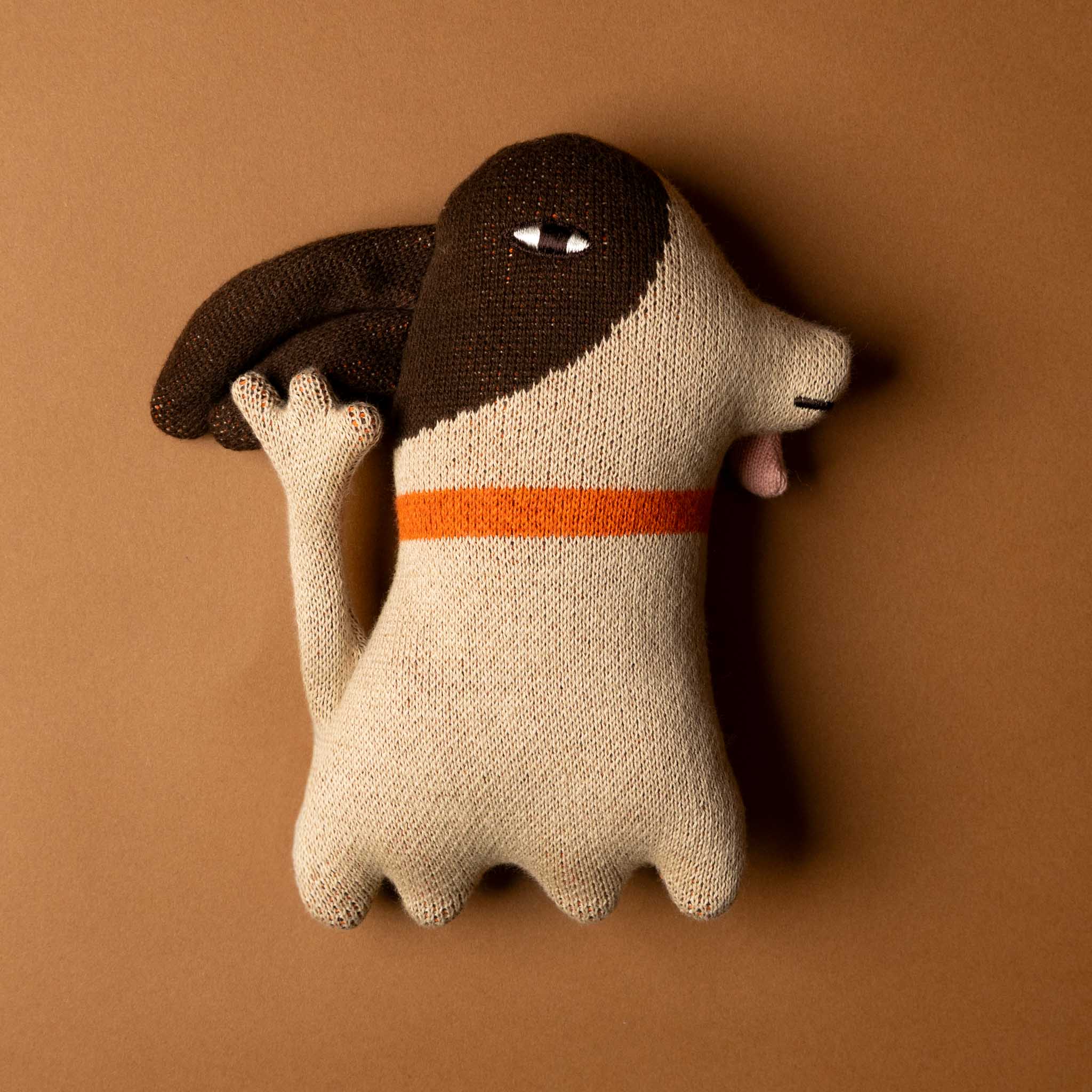 Knitted-wee-stanley-dog-stuffed-animal-with-orange-collar-waving