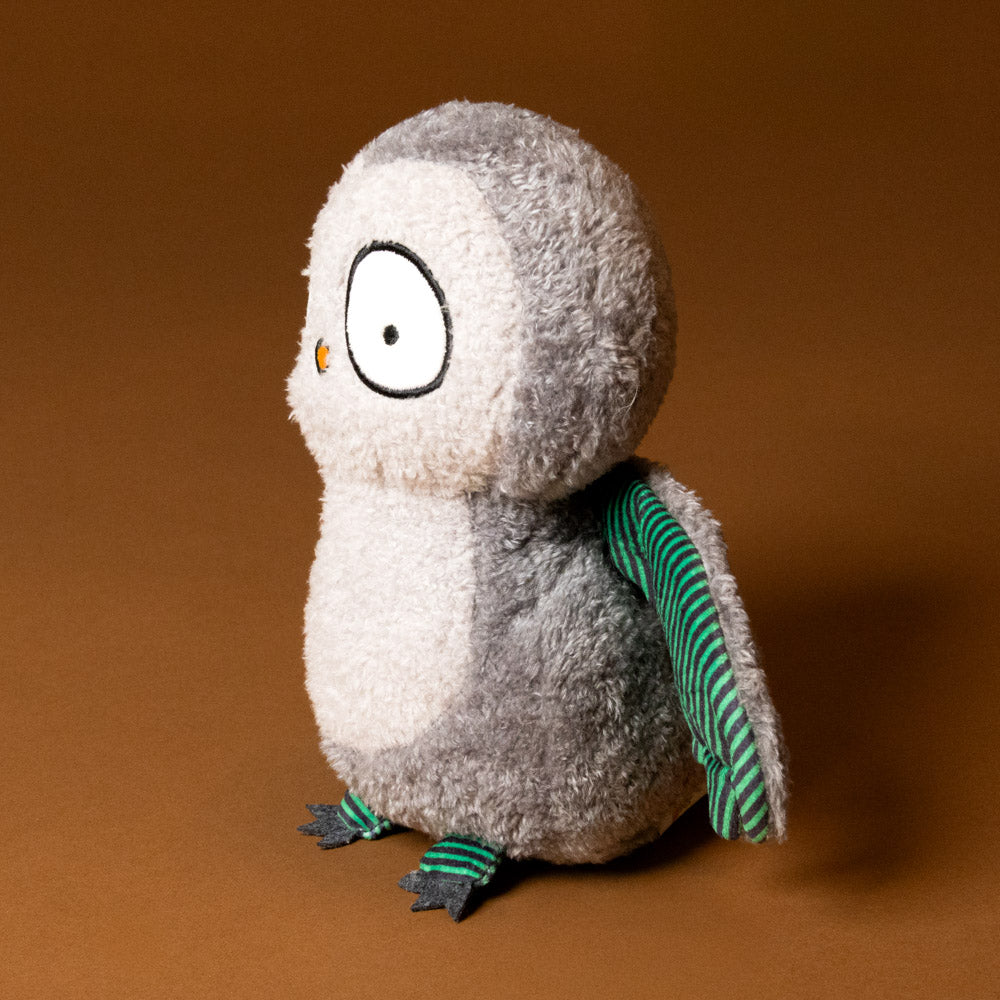 whooo-the-owl-stuffed-animal with green striped wings on a brown background-side