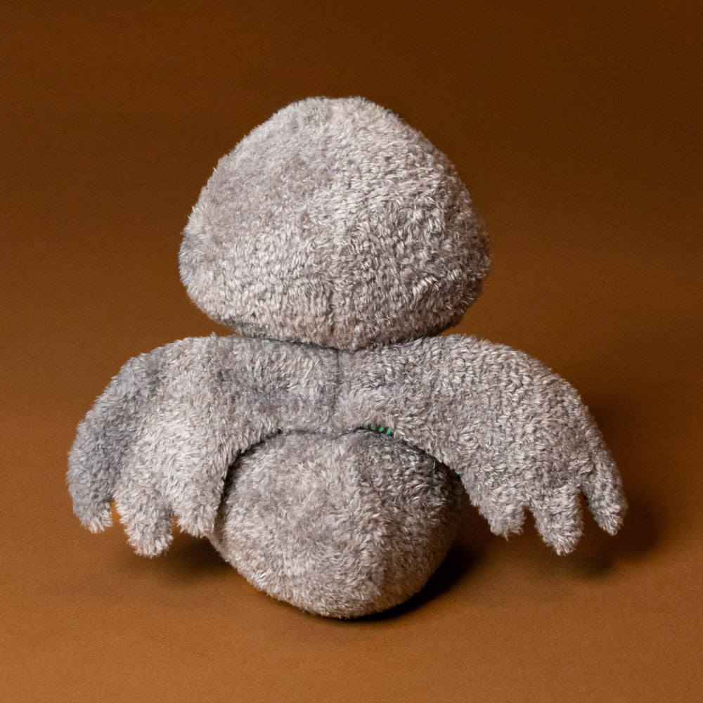 whooo-the-owl-stuffed-animal with green striped wings on a brown background-wings-and-back