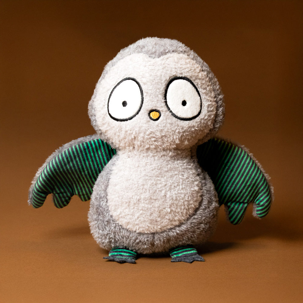 whooo-the-owl-stuffed-animal with green striped wings on a brown background-front