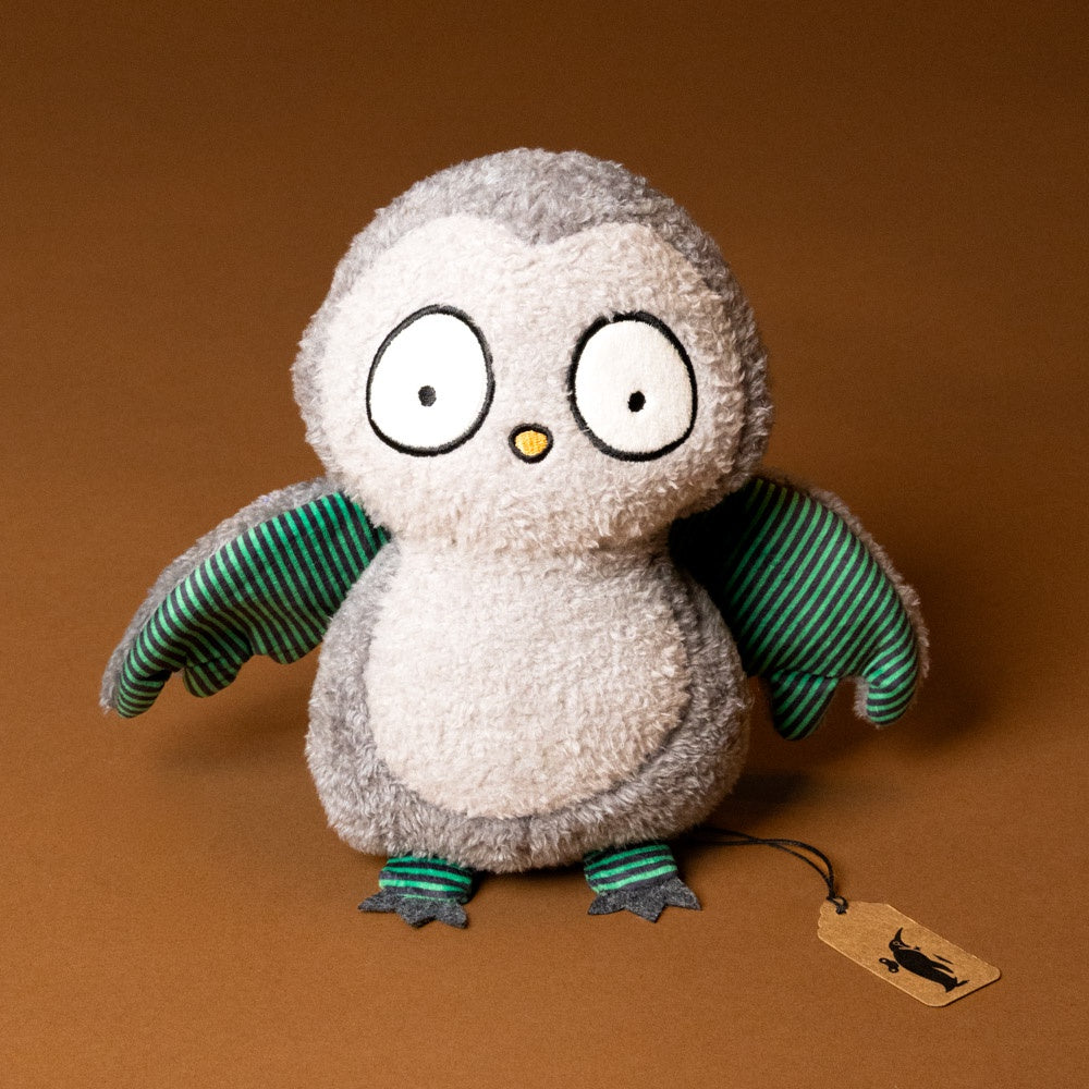 whooo-the-owl-stuffed-animal with green striped wings on a brown background