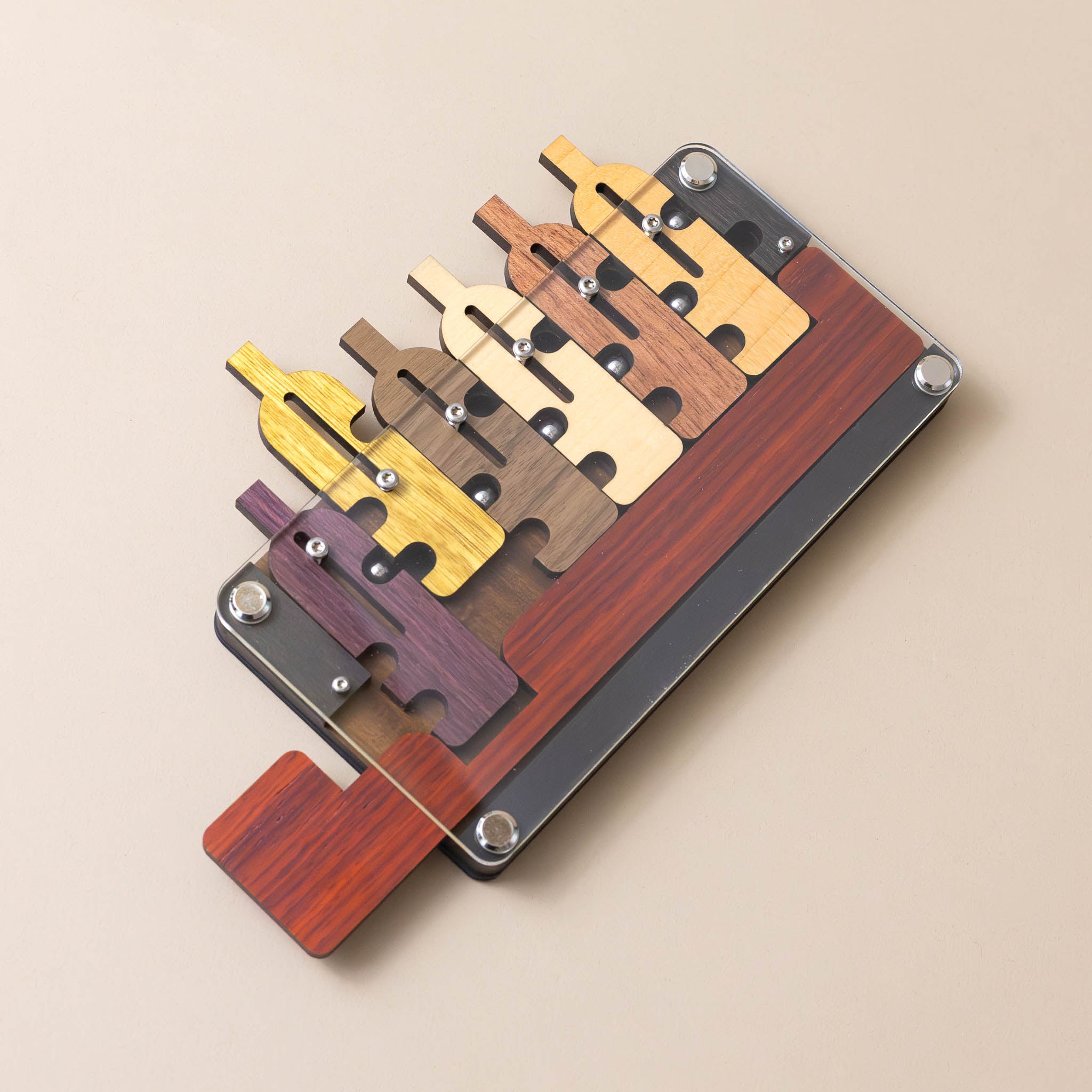 wooden-bottles-up-puzzle-various-wood-colors-with-metal-balls-and-acrylic-barrier