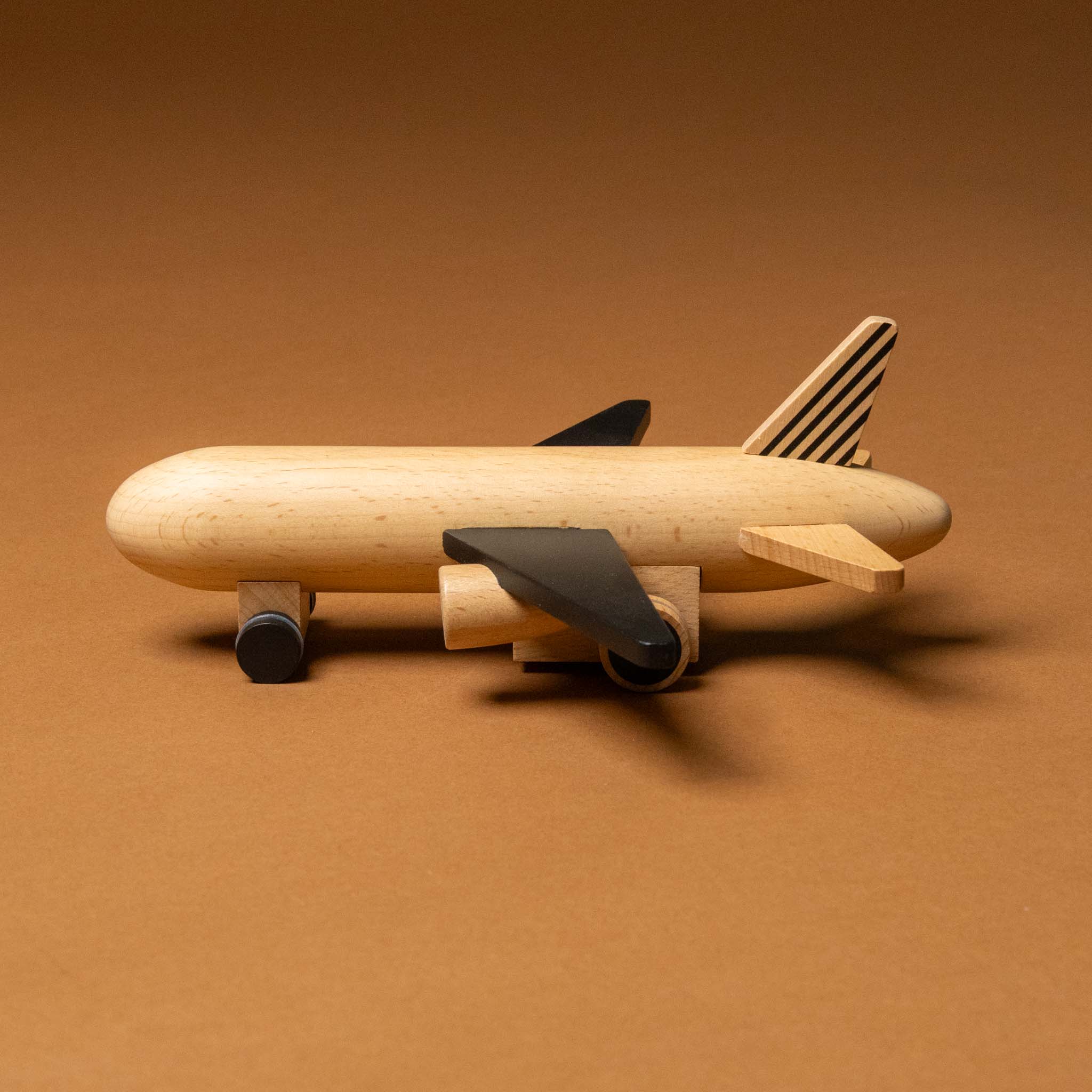 wooden-pull-and-go-jet-airplane-black-side-with-striped-tail