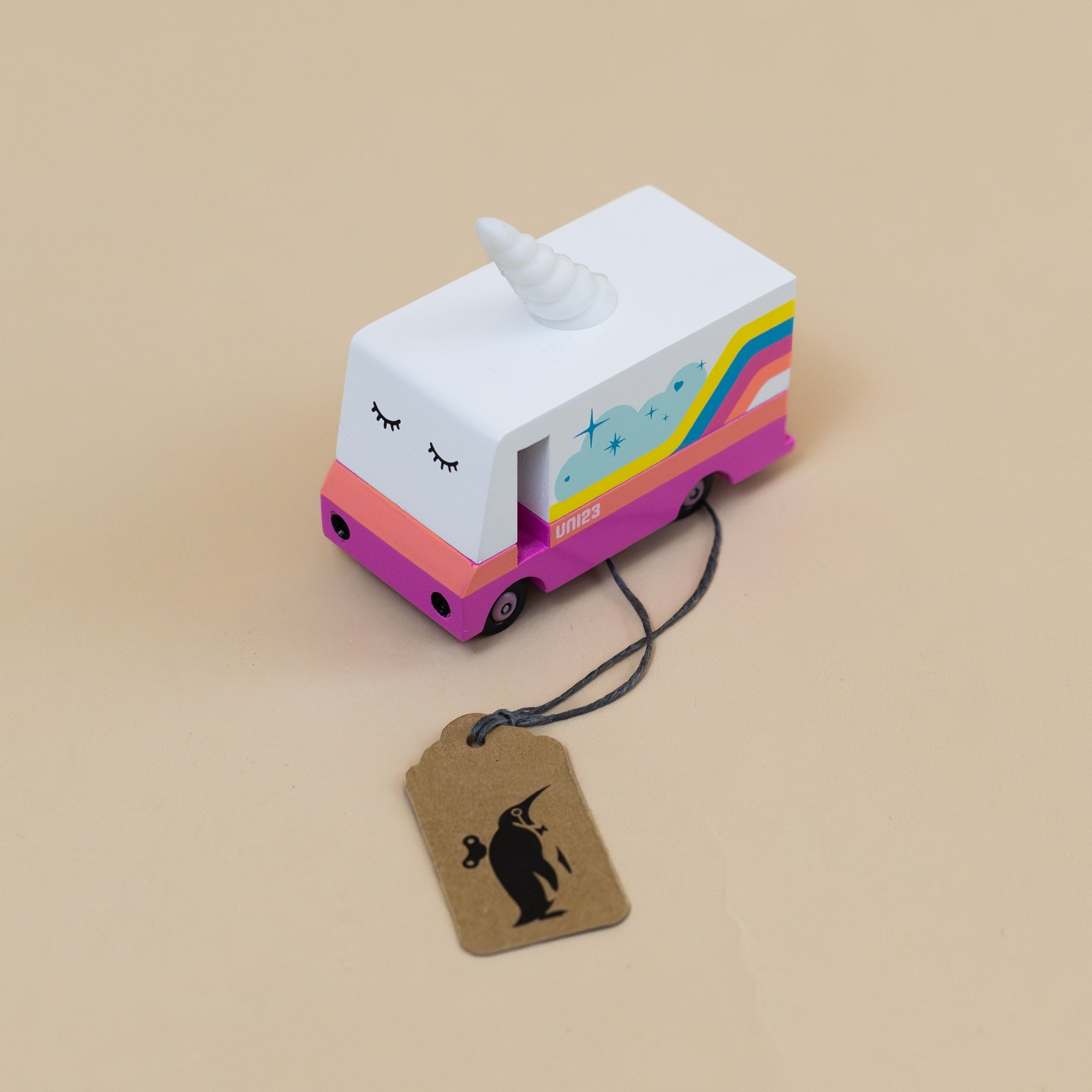 rainbow-adorned-pink-and-white-wooden-candyvan-with-unicorn-horn