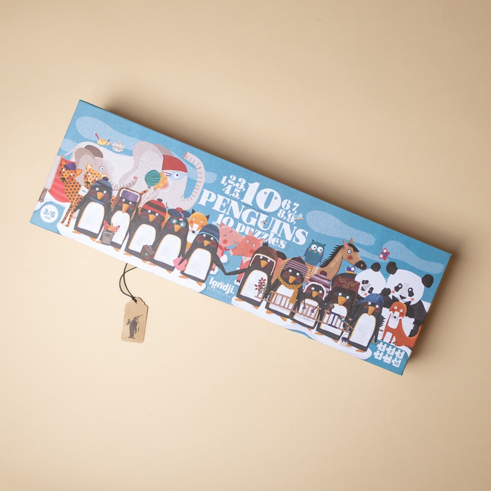 10-penguins-puzzle box with cartoon penguins and other animals on a beige background
