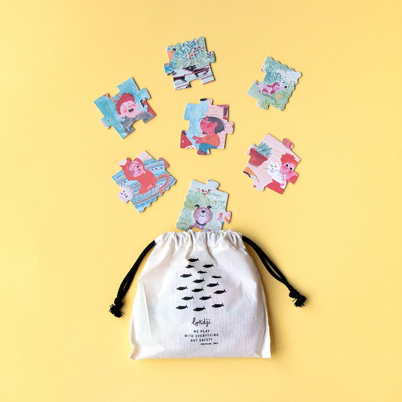 Set of colorful children's puzzles with a drawstring bag on a yellow background