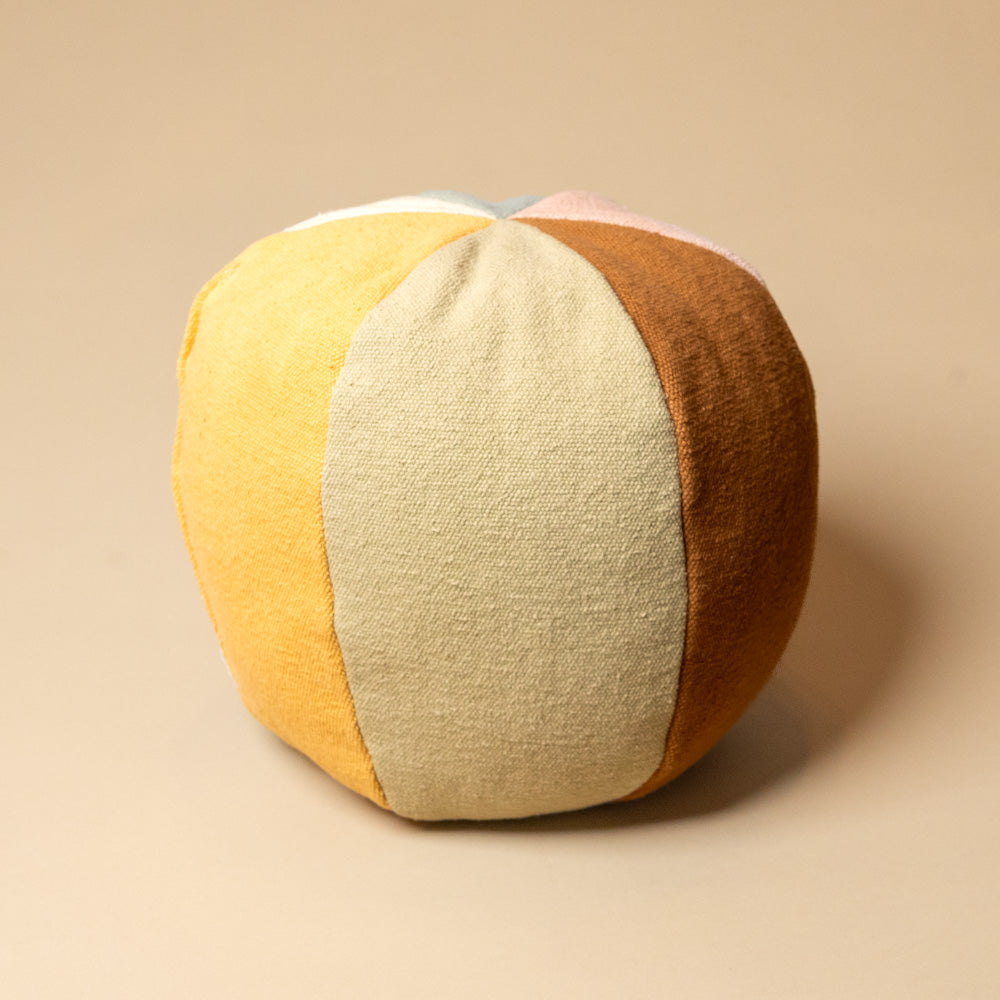 Playful-Ball-CushionColor-blocked spherical pillow on a beige background