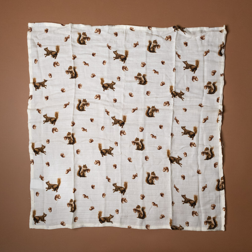 bamboo-burpie-set-chipmunk White fabric with brown chipmunk and acorn pattern on a brown background