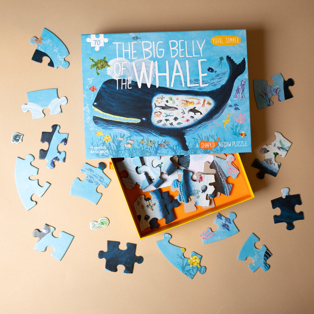 Puzzle set with 'The Big Belly of the Whale' packaging on a beige background