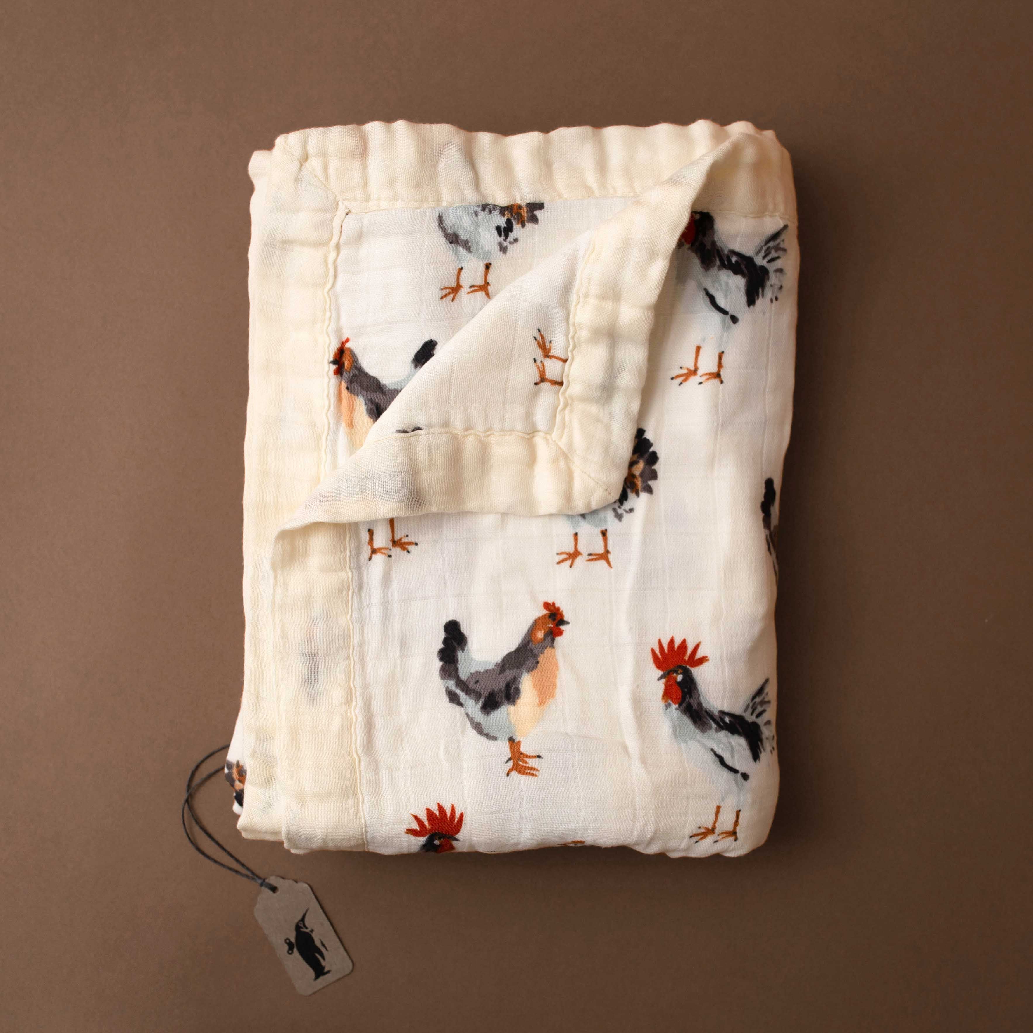 big-lovie-chickens Folded baby blanket with chicken pattern on a brown background