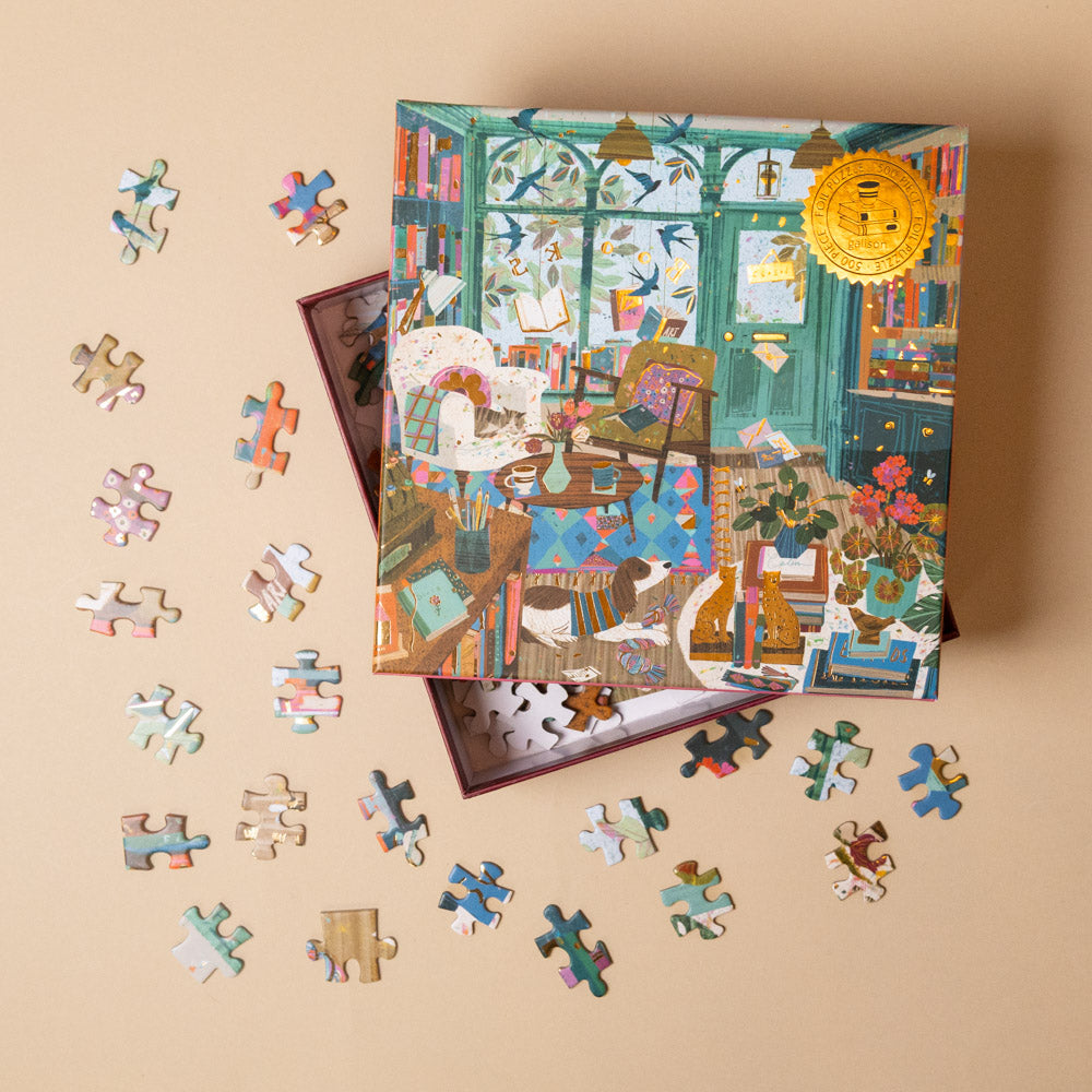 bookshop-afternoon-500-piece-puzzlewith completed pieces and a box on a beige background