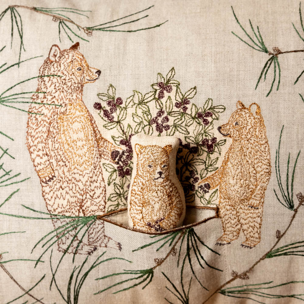 briar-bears-pocket-pillow of bears with a floral arrangement on a fabric background