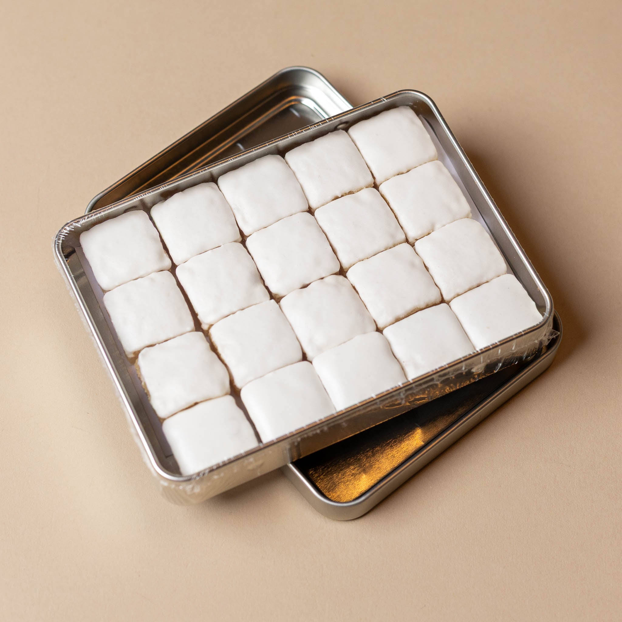 calisson-from-saint-remy-gift-tin Metal tin filled with white cubes on a beige background