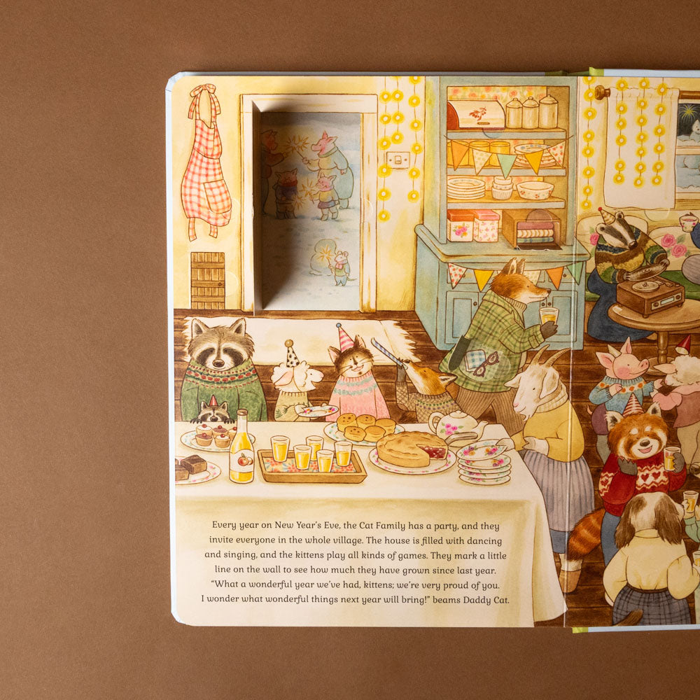 cat-family-four-seasons-life-the-flap-book Illustrated book page with a festive scene of animals celebrating New Year's Eve.