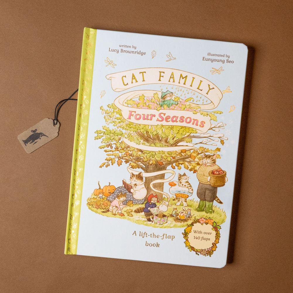 Children's book titled 'Cat Family Four Seasons' on a brown background