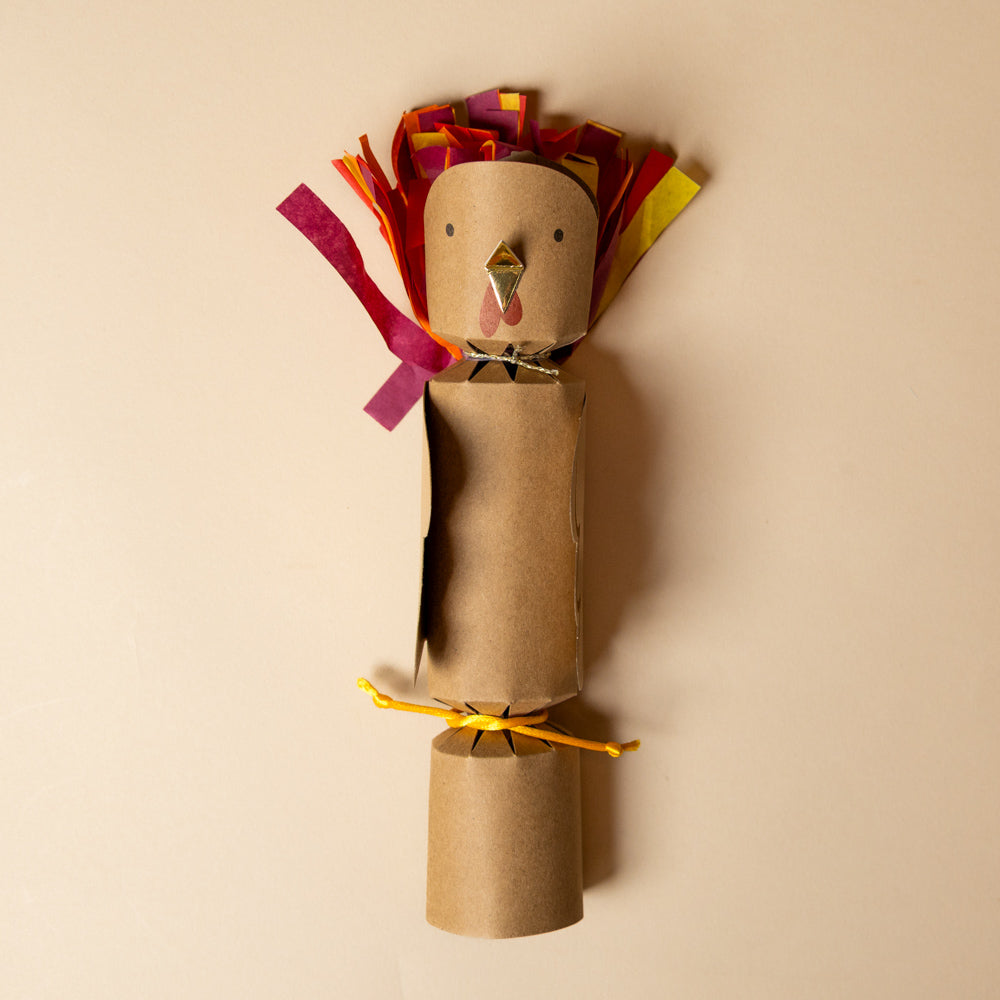 celebration-crackers-turkeys with colorful feathers on a beige background