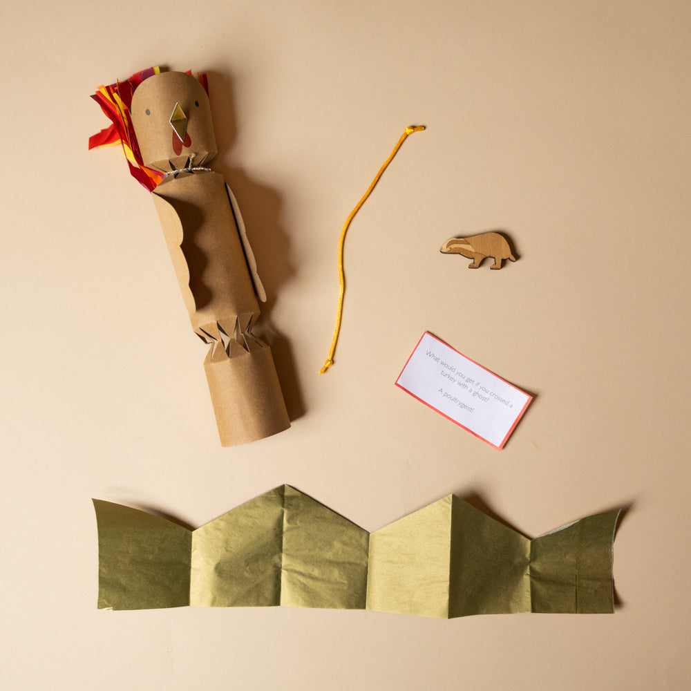 celebration-crackers-turkeys with a bear figure, gold paper hat, and a card on a beige background