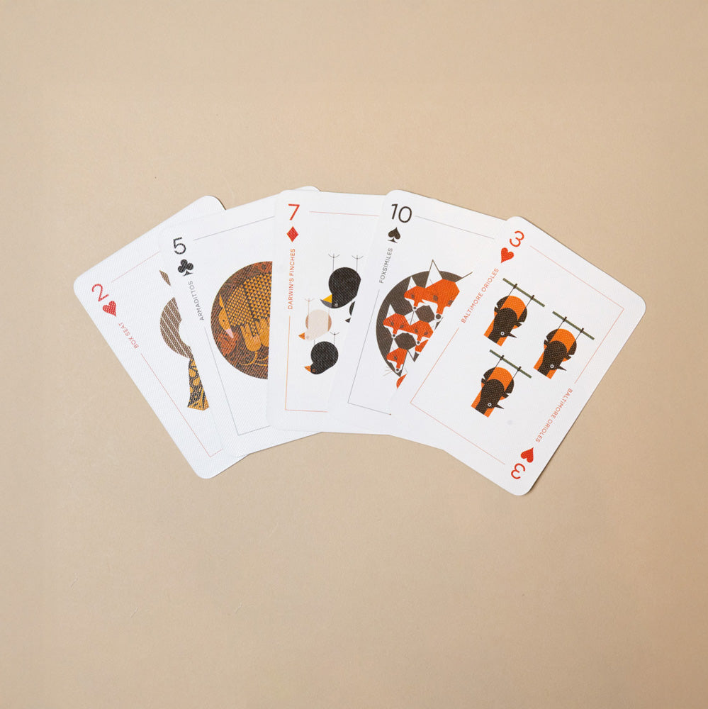 charley-harper-Set of playing cards with unique designs on beige background