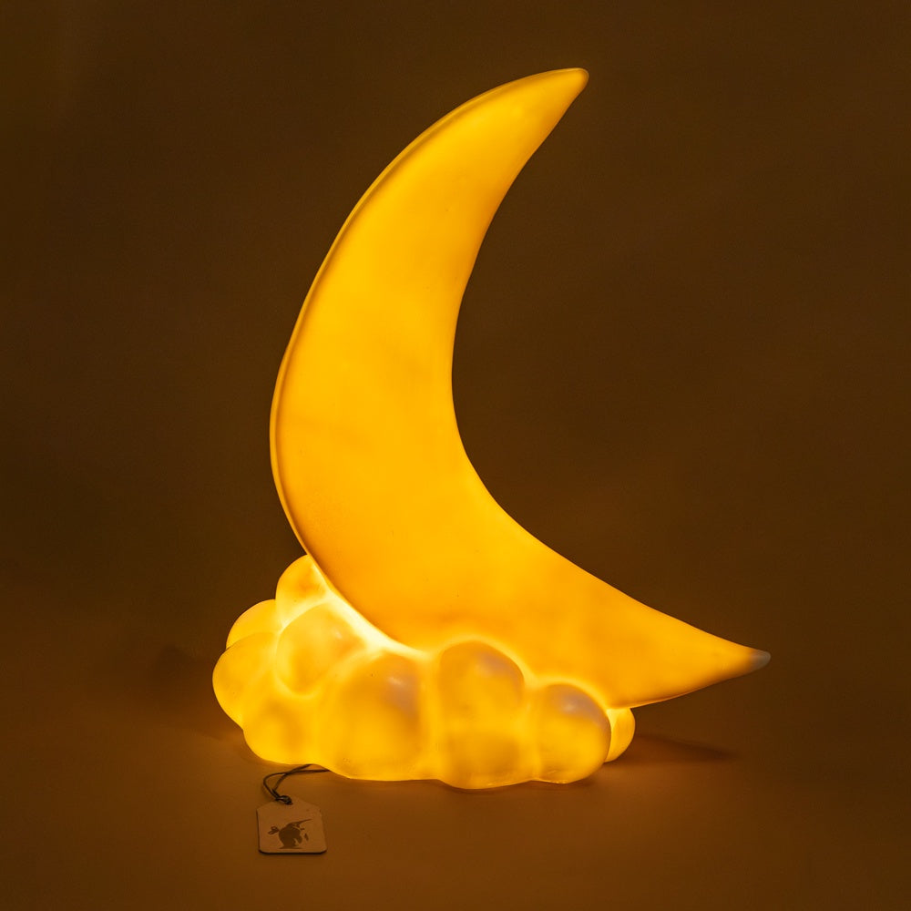 crescent-moon-lamp night light with a cloud base on a dark background