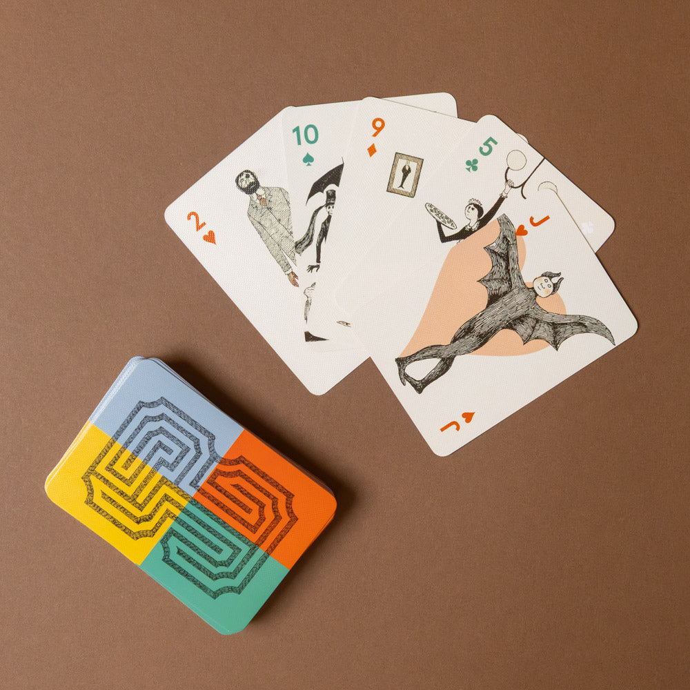 edward-gorey-playing-cards-set Playing cards with unique designs on a brown background
