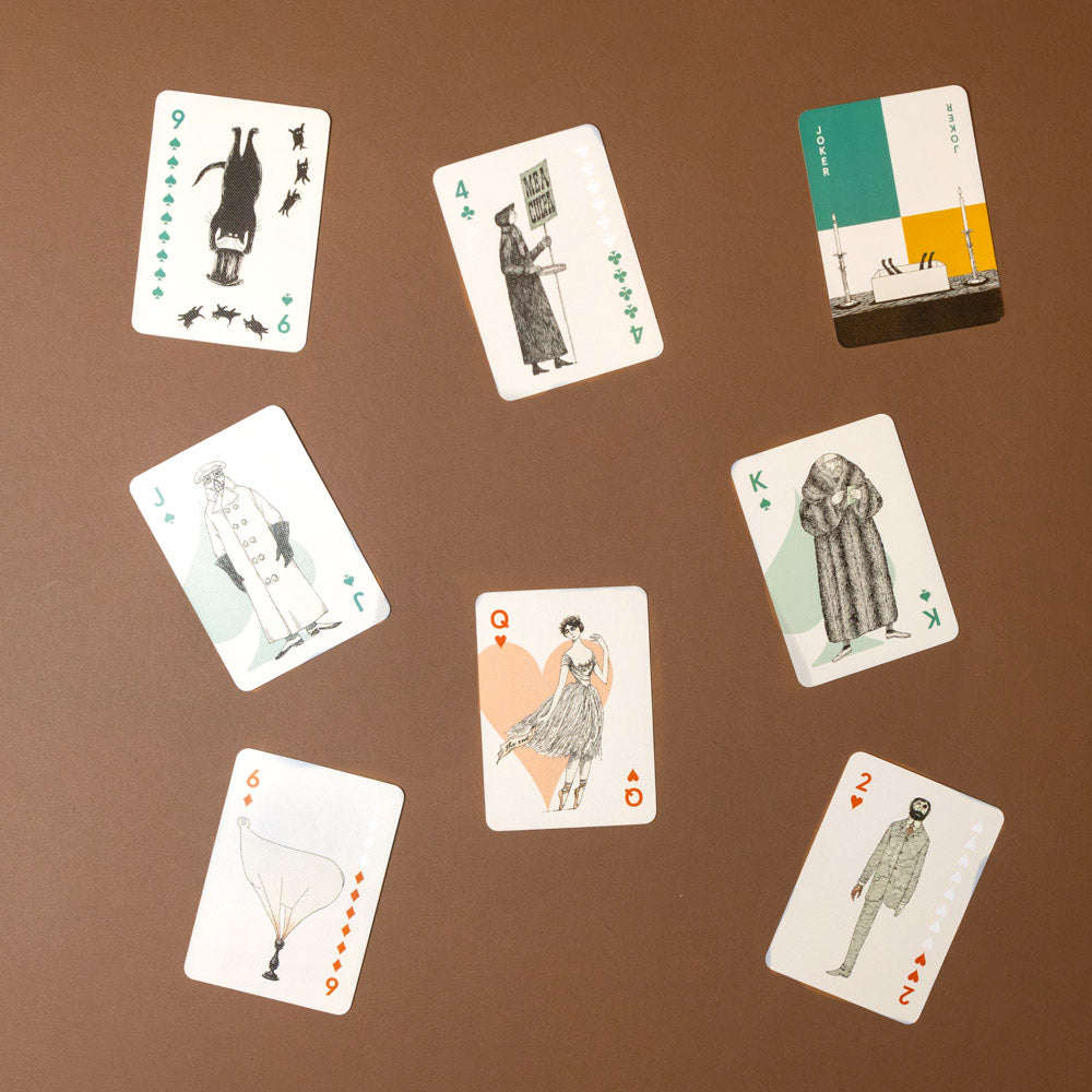 edward-gorey-playing-cards-set Set of playing cards with illustrated figures on a brown background