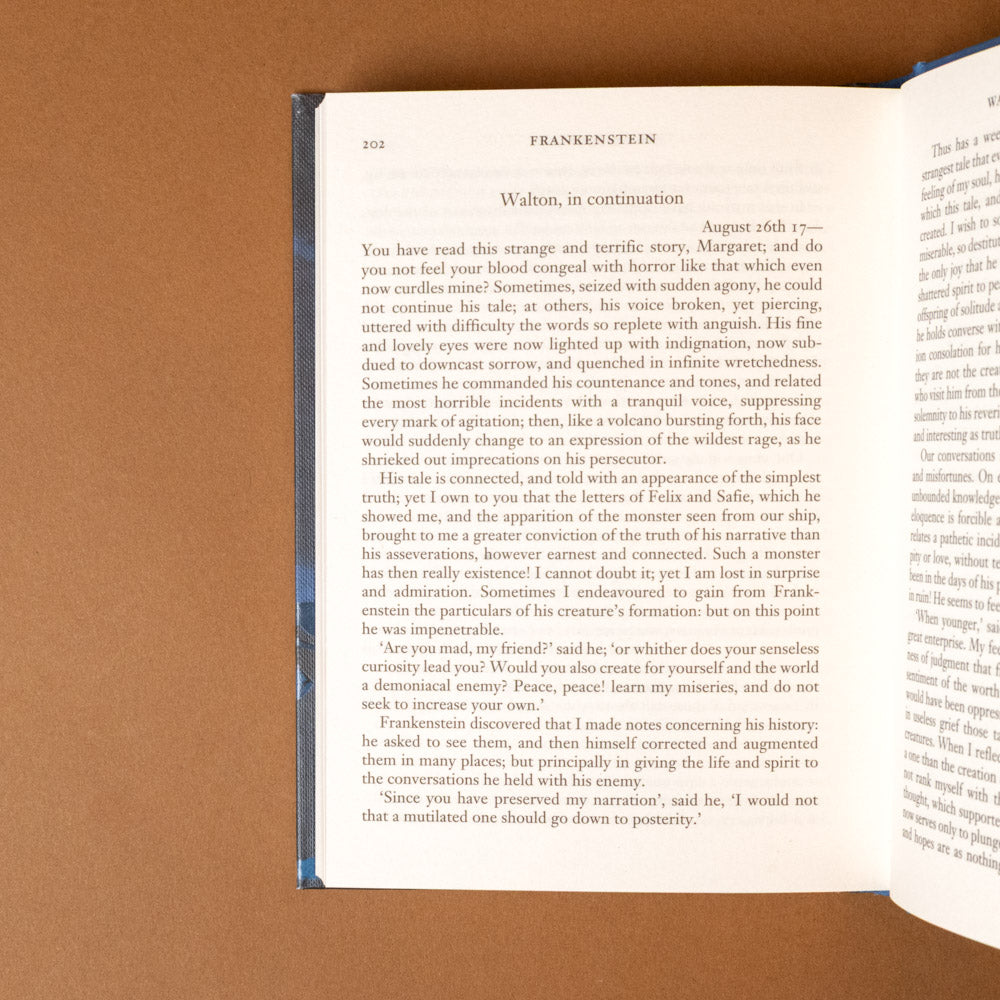 frankenstein Open book on a brown surface with visible text