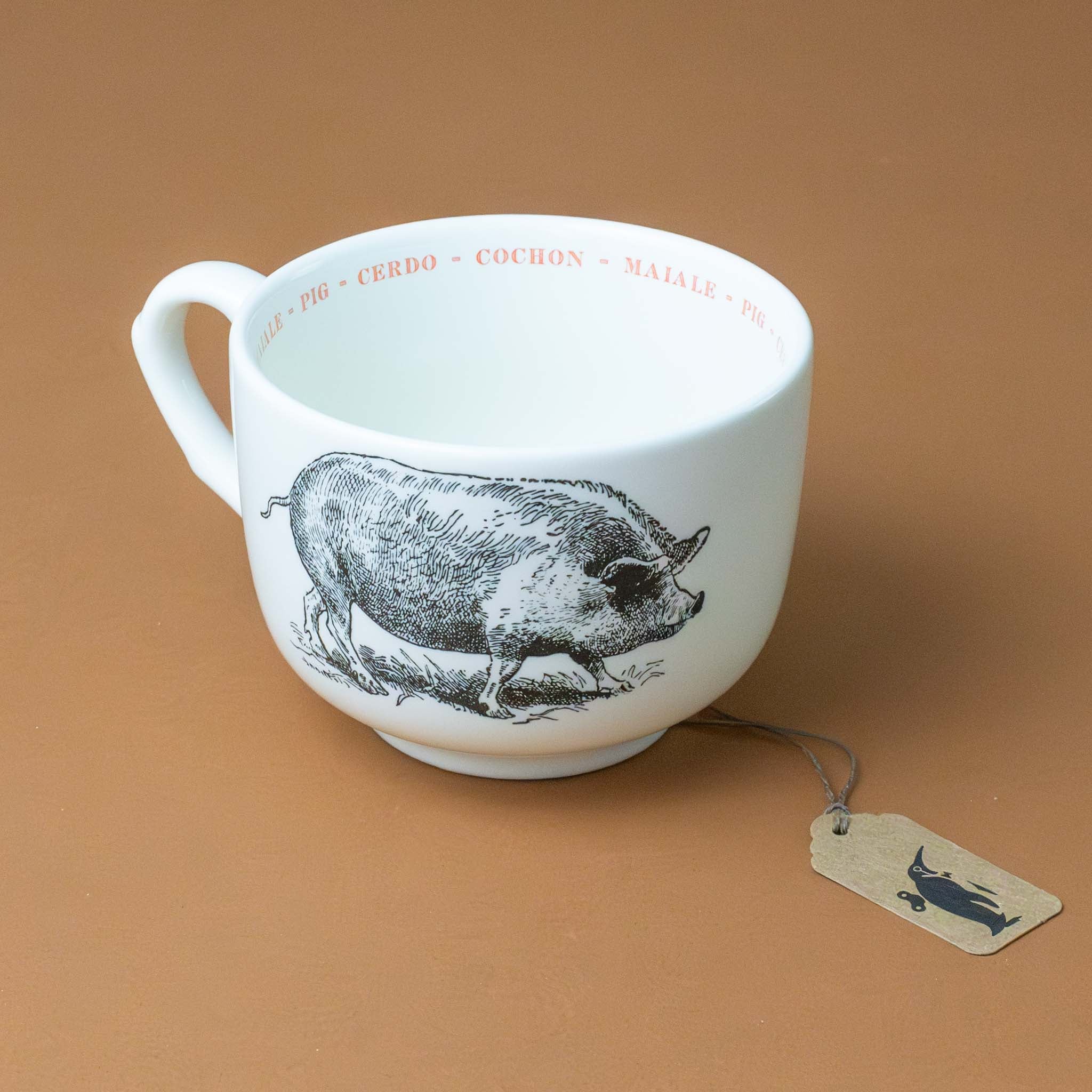 white-grande-stoneware-cup-black-illustration-pig-with-the-word-pig-in-pink-in-several-different-languages-on-interior-of-cup