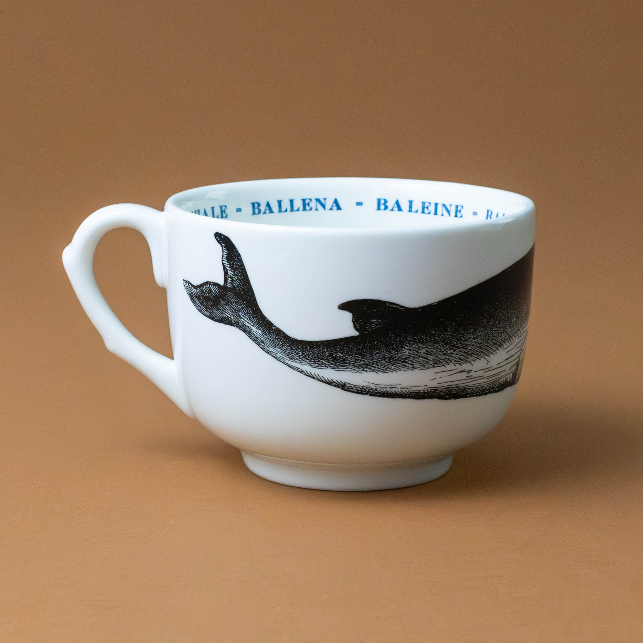 white-grande-stoneware-cup-black-illustration-whale-with-the-word-whale-in-blue-in-several-languages-on-interior-of-cup