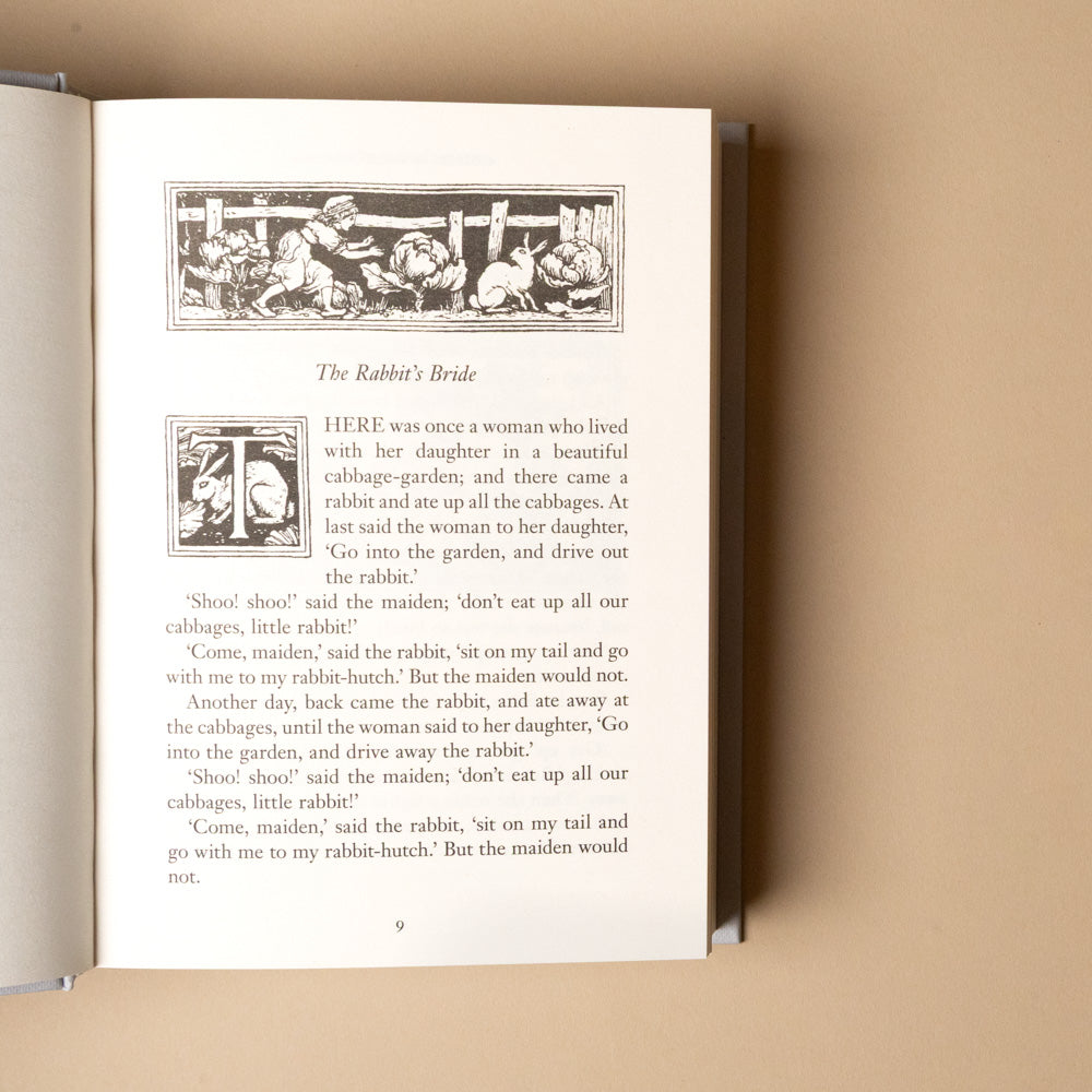 grimms-fairy-tales Open book  titled the-rabbits bride with illustrated text on a beige background