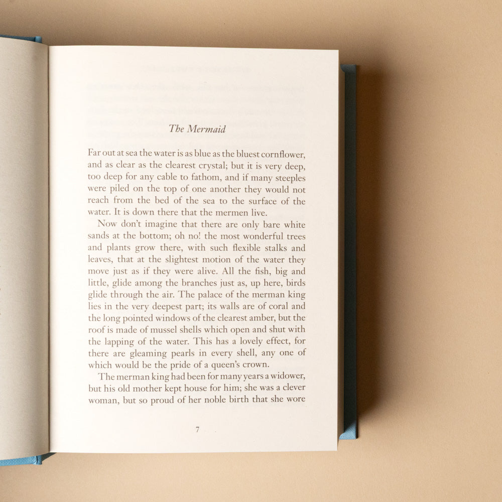 hans-christian-andersen-fairy-tales Open book titled the mermaid with text on a beige background