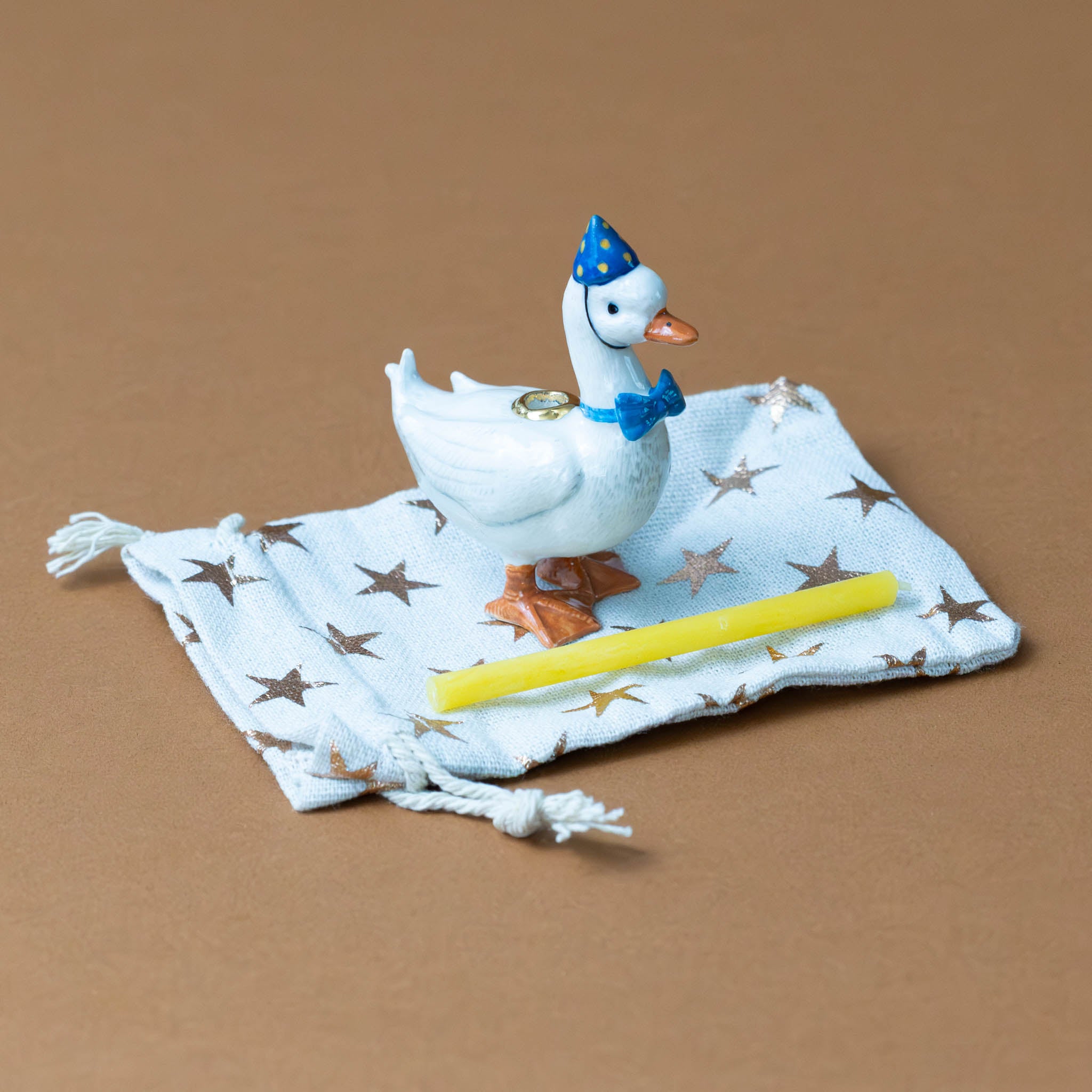 heirloom-porcelain-cake-topper-goose-blue-hat-beeswax-candle-bag