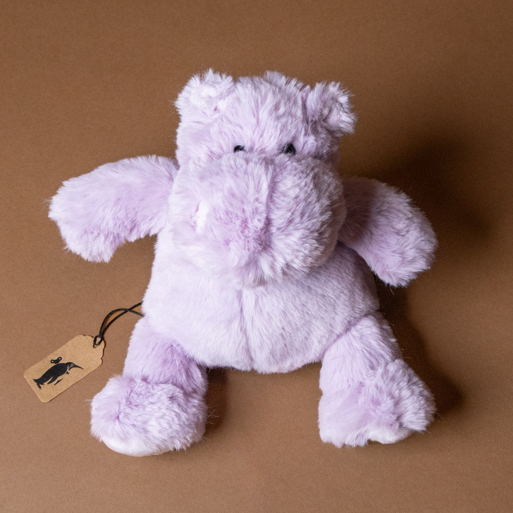 hip-hippo-lilac-petite with a tag on a brown background