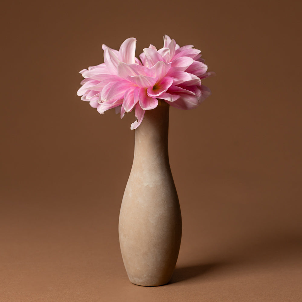 holden-bud-vase-large Pink flower in a beige vase on a brown background