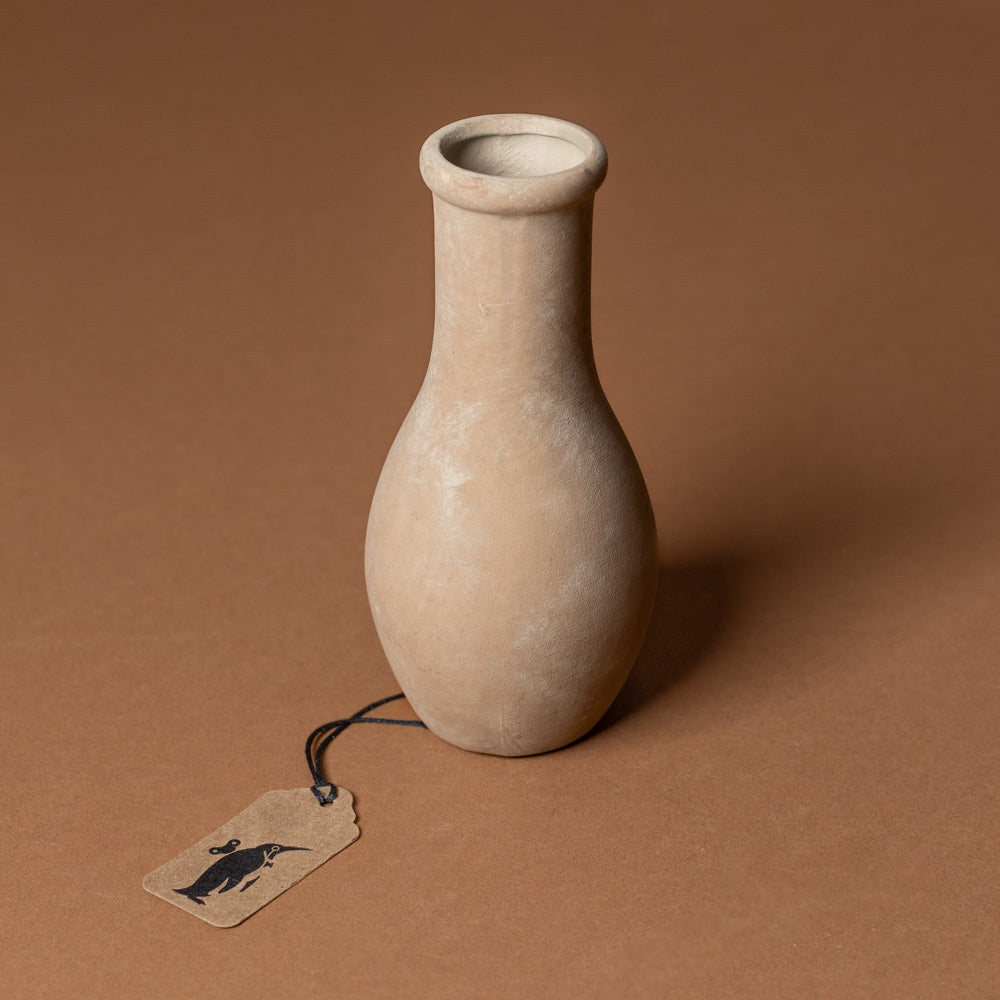 holden-bud-vase-medium Beige ceramic vase with a tag on a brown background