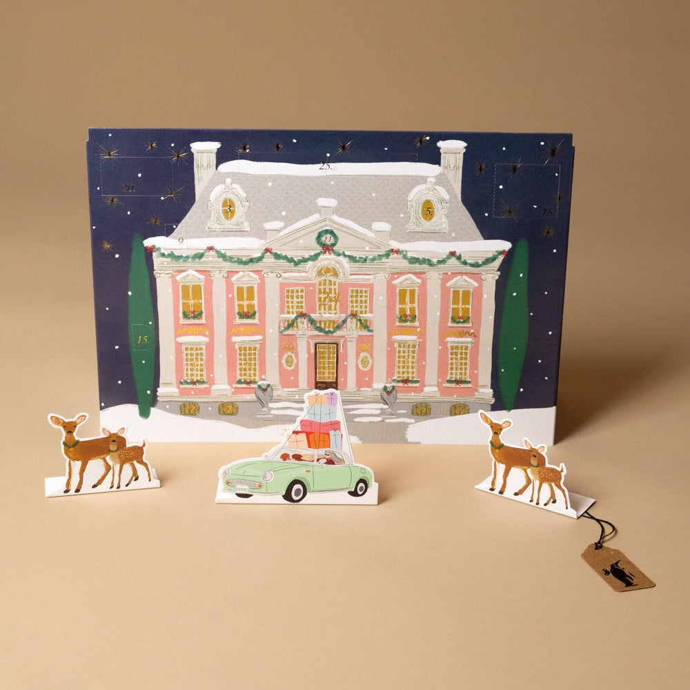 magical-holiday-night-advent-calendar with a snowy house, car, and deer on a beige background