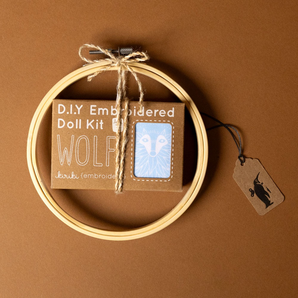 make-your-own-embroidered-animal-kit--wolf D.I.Y Embroidered Doll Kit with hoop and tag on brown background